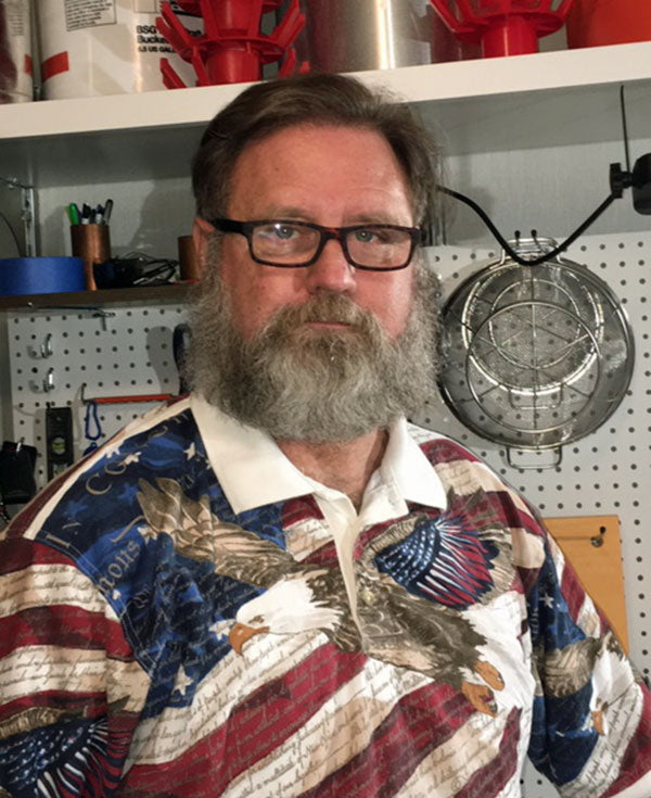 a man with glasses in a patriotic shirt