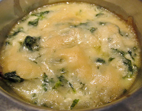 Close up of cheesy kale gratin