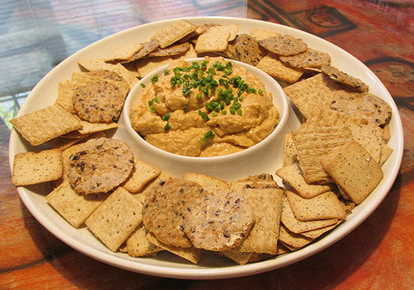 Crackers on a plate with cheese in the center