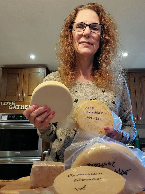 Woman holding pieces of cheese.