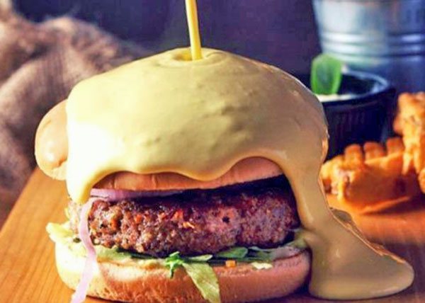 A cheeseburger with cheese melting on top