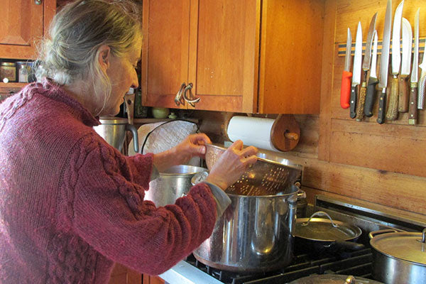 woman checkin strainer and pot