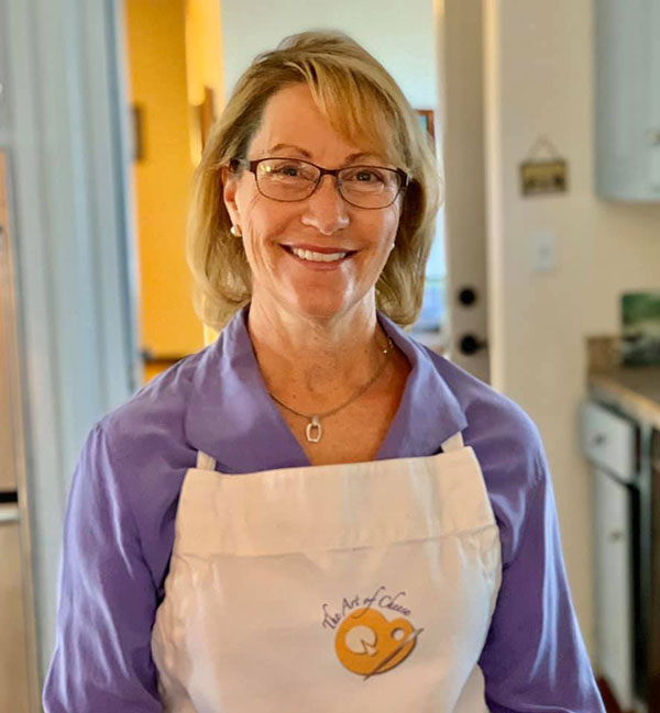 A woman in an apron smiling